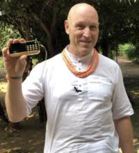 Devotee holding Srila Prabhupada lecture device